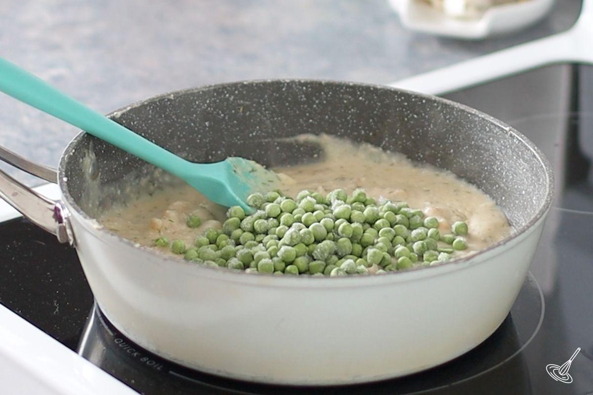 Frozen green peas added to a seafood cream sauce. 