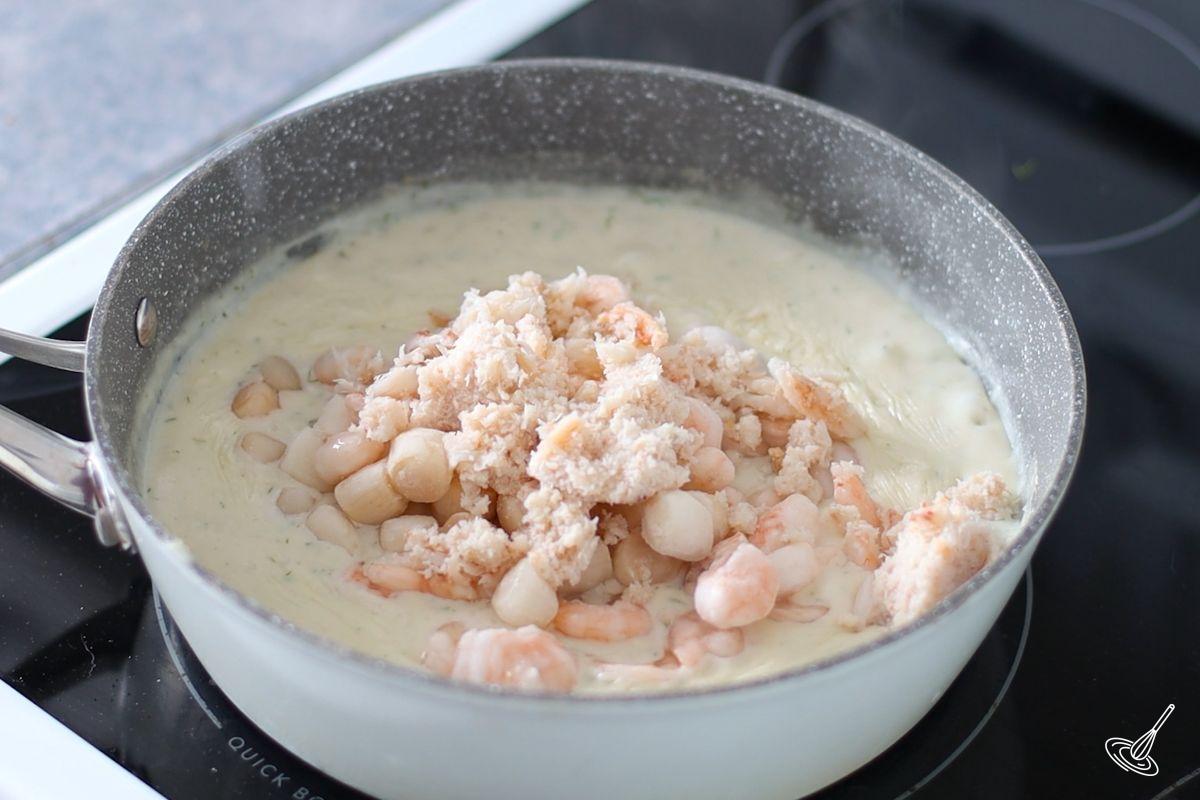 Seafood in a saucepan of bechamel.