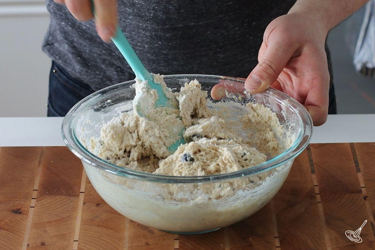 Someone mixing a Cottage Cheese Blueberry Muffins batter.