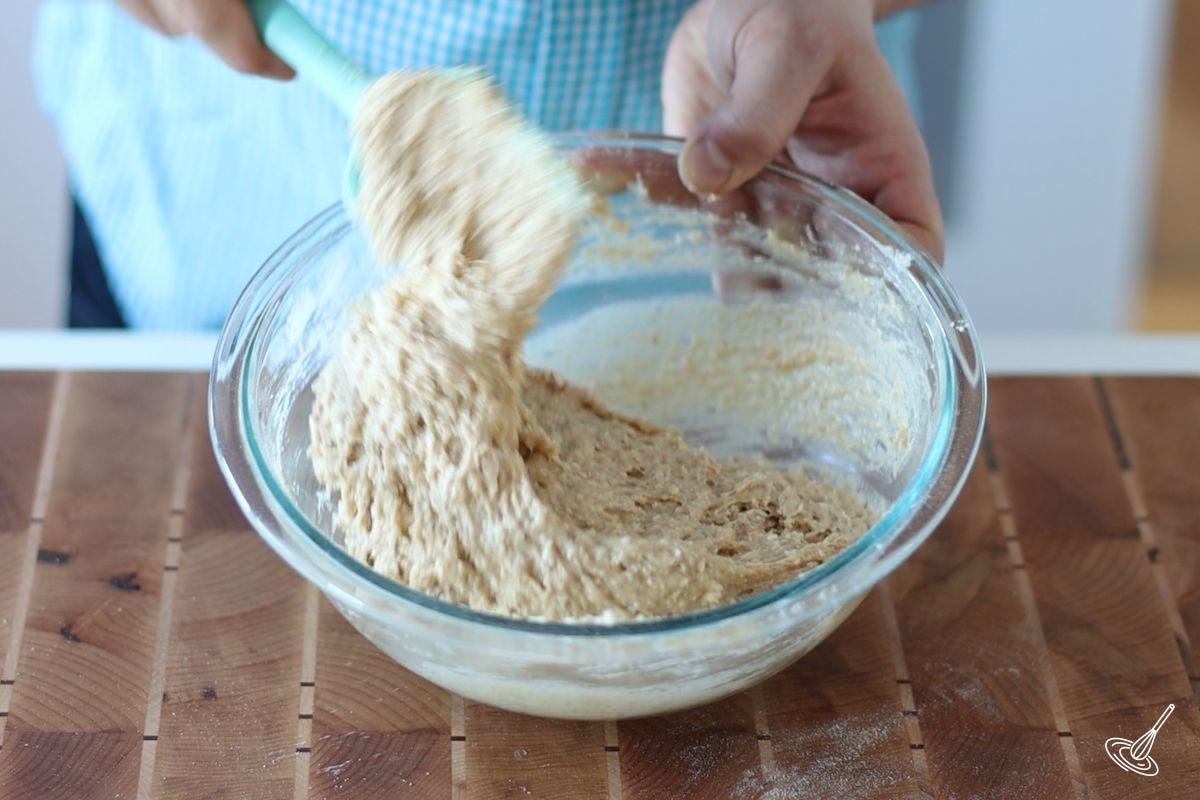 Someone using a spatula to fold together Cottage cheese banana bread mixture.