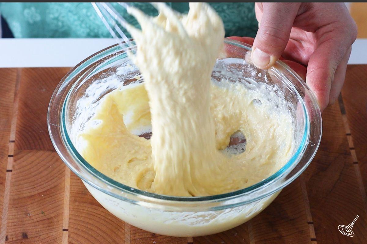 Someone whisking Pâte à Crêpes.