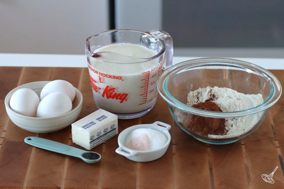 Ingredients to make Chocolate French Crepes including flour, milk, eggs, and butter.