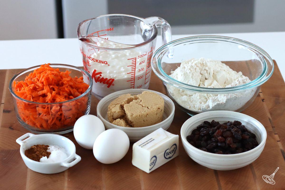 Ingredients to make muffins, including; cottage cheese, carrots, flour, and sugar.