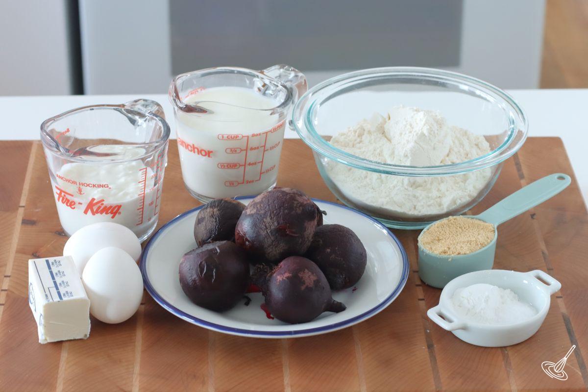 Ingredients to make beet pancakes, including roasted beets, flour, cottage cheese, and eggs.