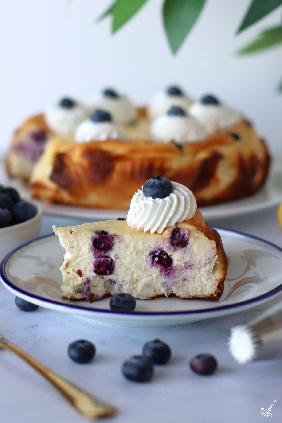 A slice of blueberry basque cheesecake on a plate. 