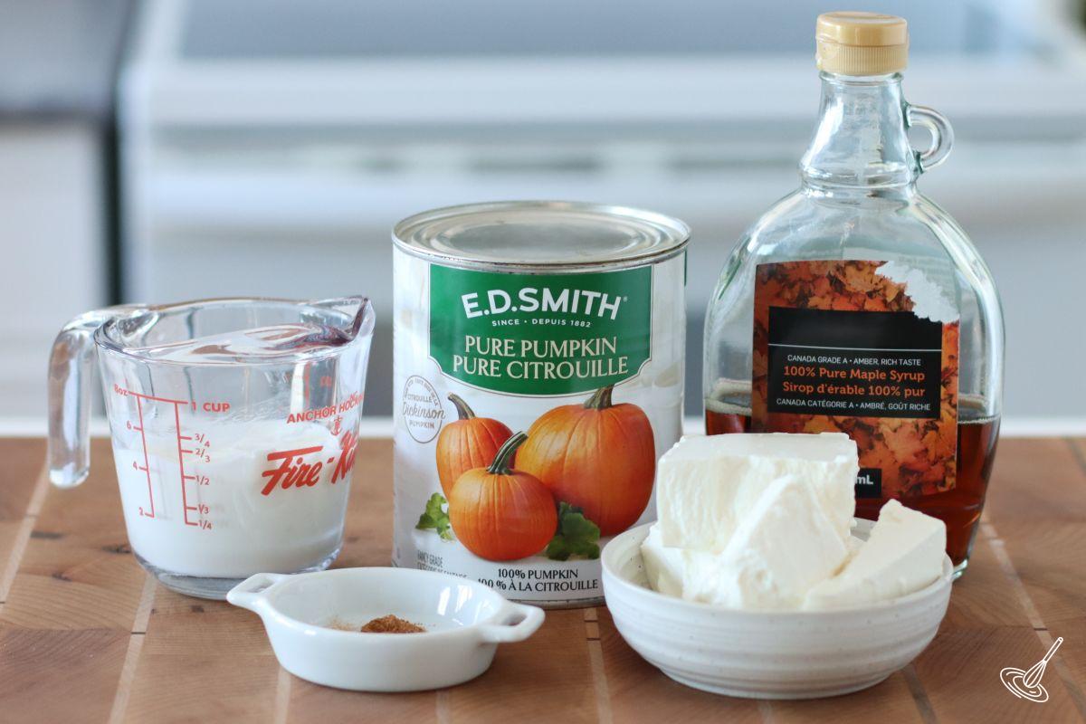 Ingredients on the kitchen counter including; pumpkin puree, feta cheese, and Greek yogurt.