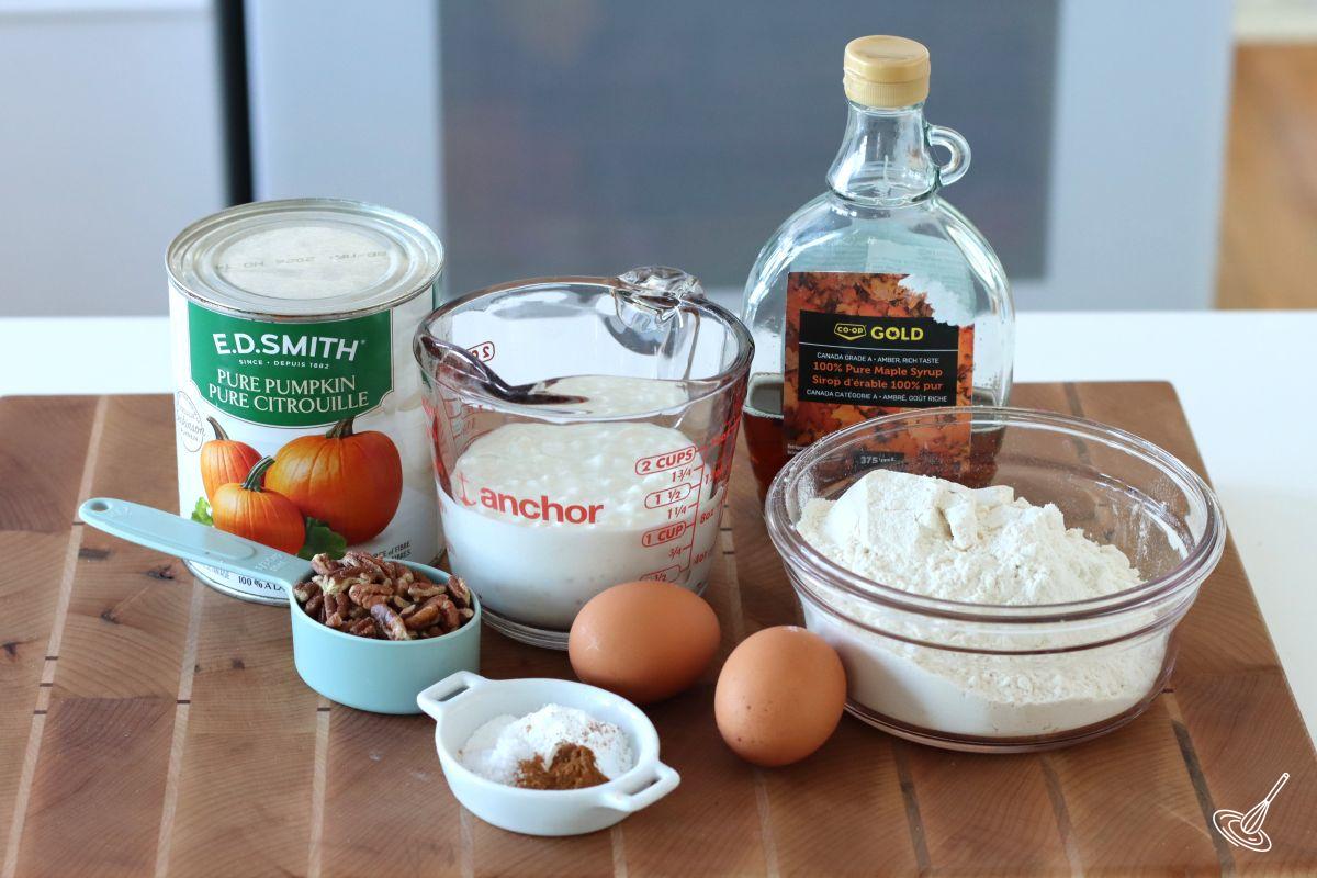 Ingredients to make muffins including flour, cottage cheese, maple syrup and eggs.
