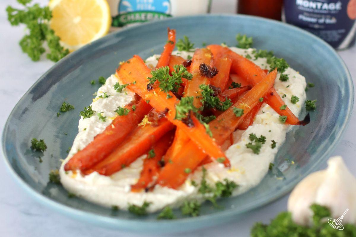 Roasted carrots with whipped feta on a plate. 