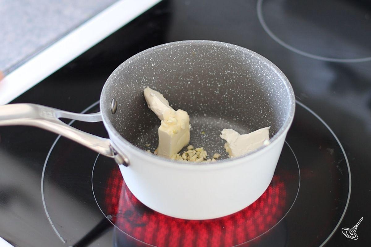 Butter and garlic in a small saucepan on the stovetop. 