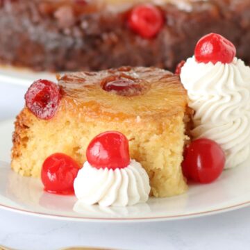A slice of Crockpot Pineapple Upside Down Cake on a plate.