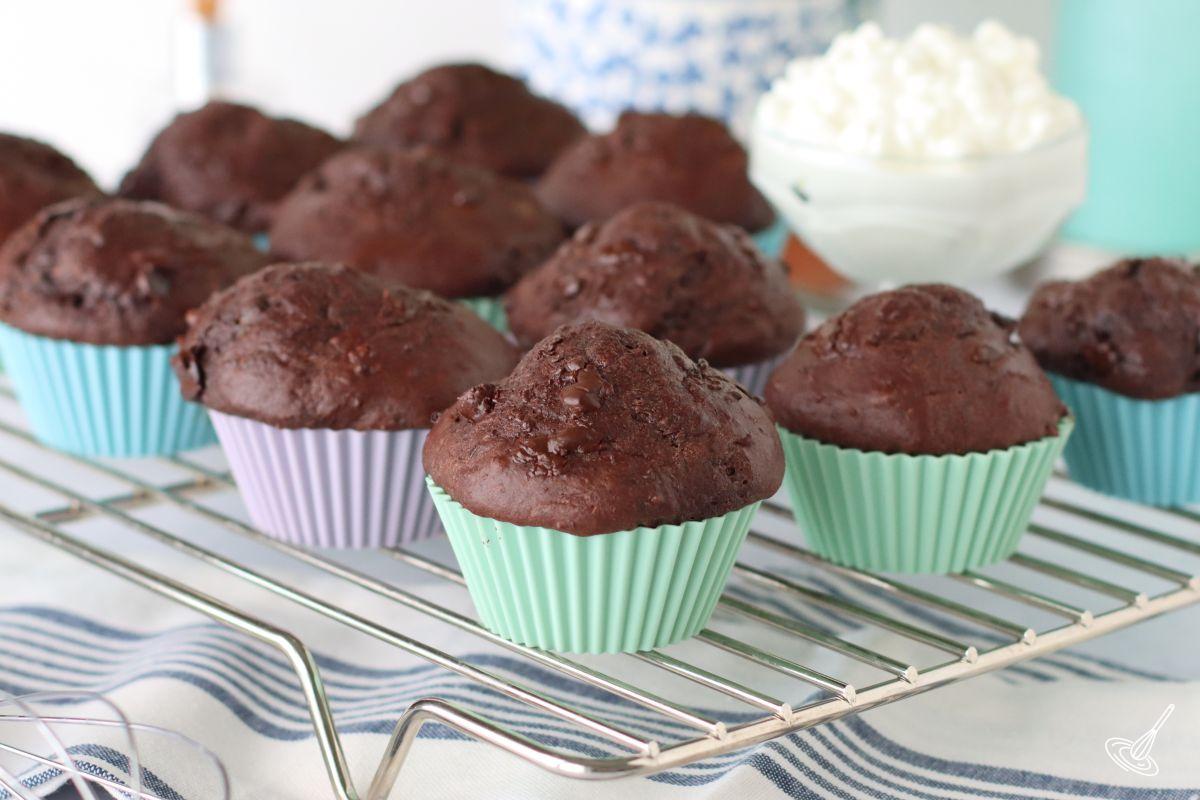 Chocolate cottage cheese muffins cooling on a rack. 