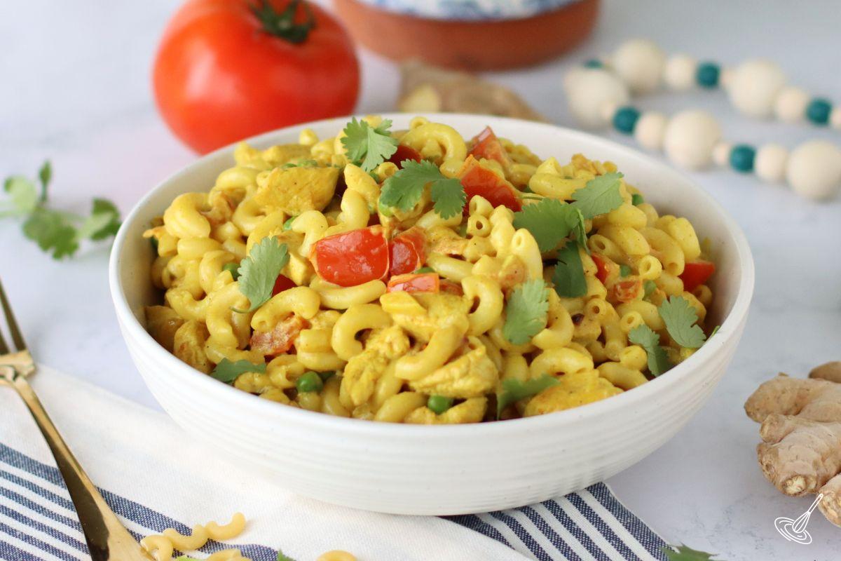Chicken curry pasta in a white serving bowl.