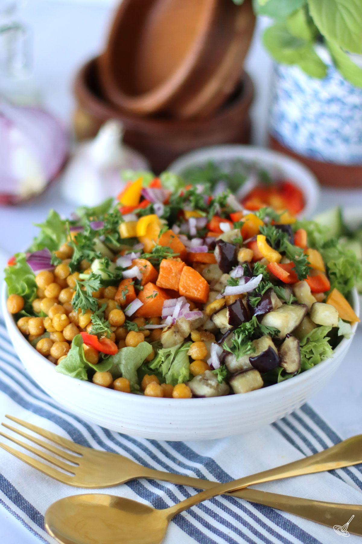 Roasted Sweet Potato and Aubergine Salad with Tahini Dressing in a serving bowl. 