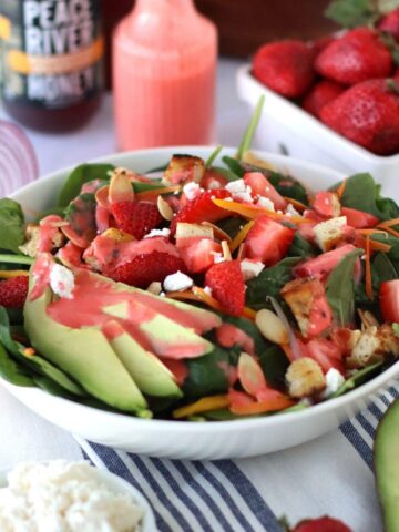 Strawberry Dressing Spinach Salad in a white bowl.