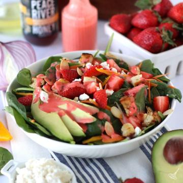 Strawberry Dressing Spinach Salad in a white bowl.