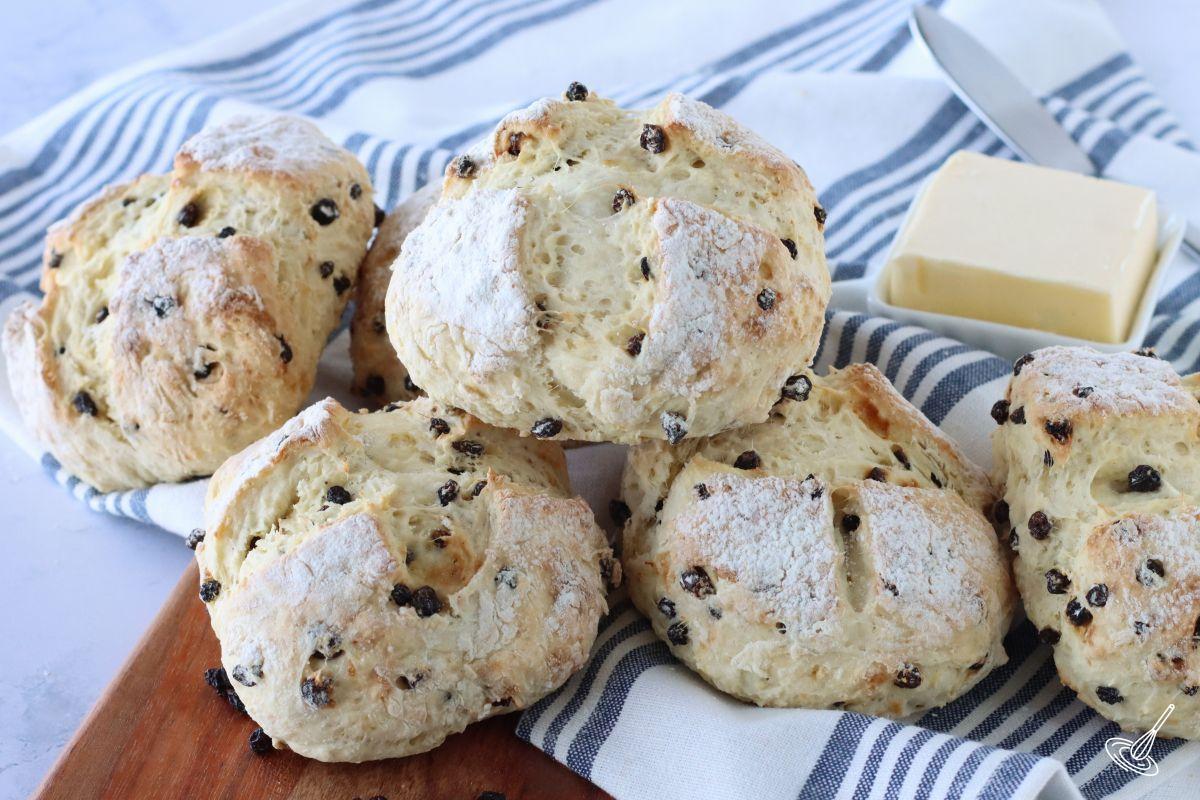 Currant Irish soda bread rolls on a dish towel. 