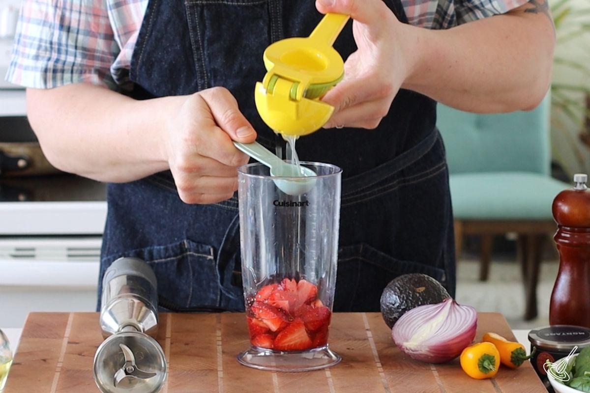Someone squeezing juice out of a lemon. 
