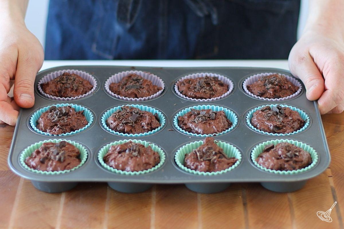 A muffin tray of chocolate cottage cheese muffins ready to be baked.
