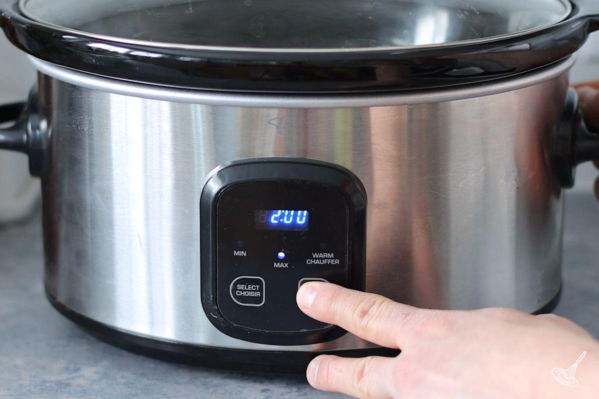 Someone setting a slow cooker for two hours. ]
