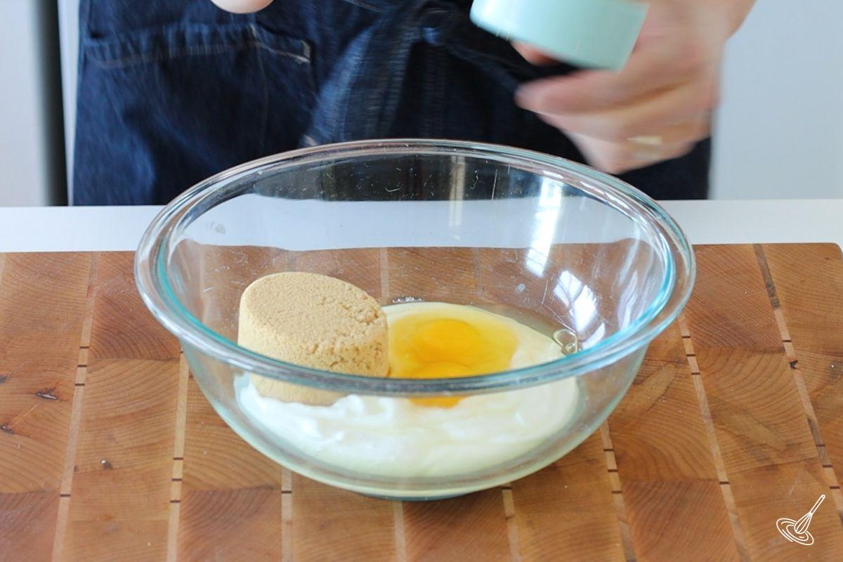 A large bowl containing blended cottage cheese, eggs, and brown sugar. 