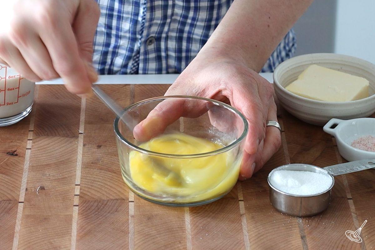 Someone whisking eggs with a fork.