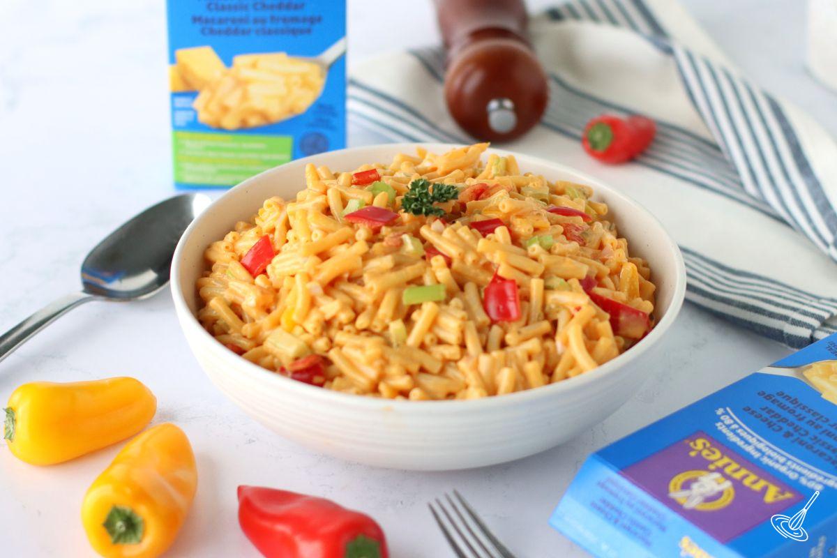 Cheesy Macaroni Salad in a white serving bowl.