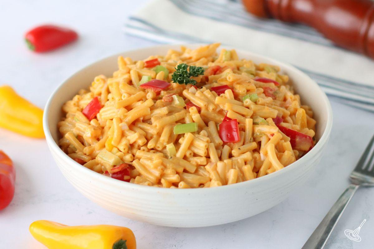 Cheesy Macaroni Salad in a white serving bowl. 