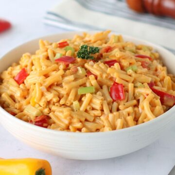 Cheesy Macaroni Salad in a white serving bowl.