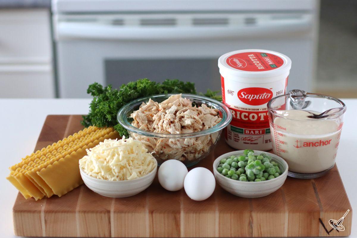 Ingredients to make Turkey Alfredo Lasagna Rollups including shredded turkey roast, lasagna noodles, and ricotta cheese.