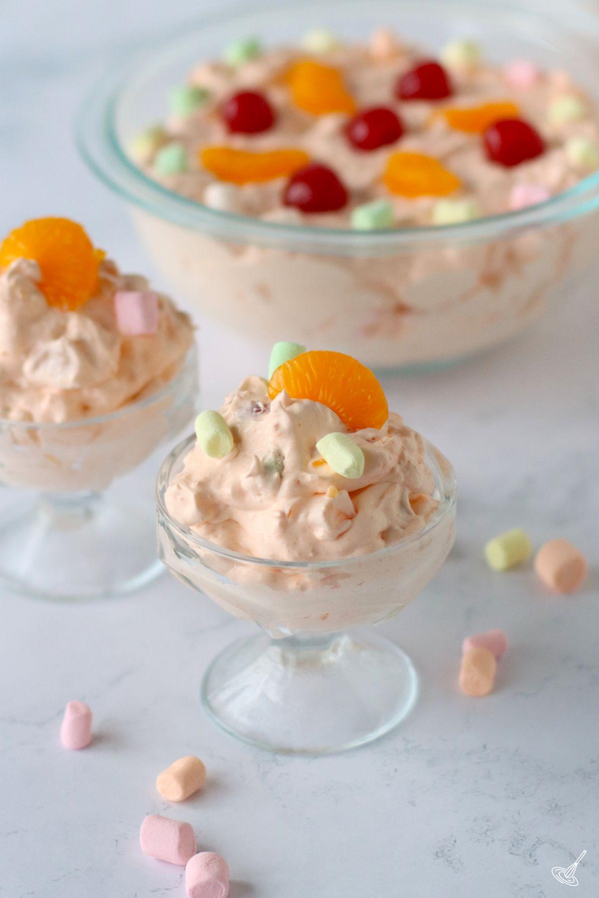 Orange Jello Cottage Cheese Salad in a parfait cup.