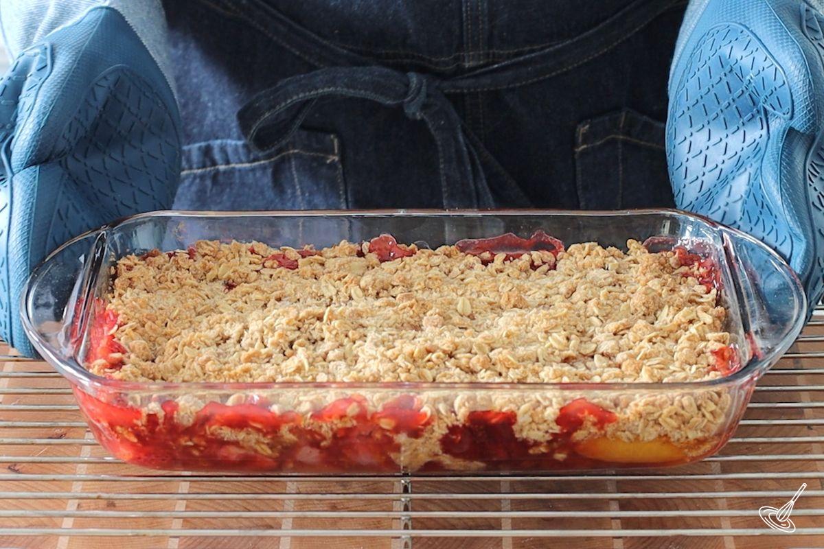 A baked Strawberry Peach Crisp on a cooling rack.