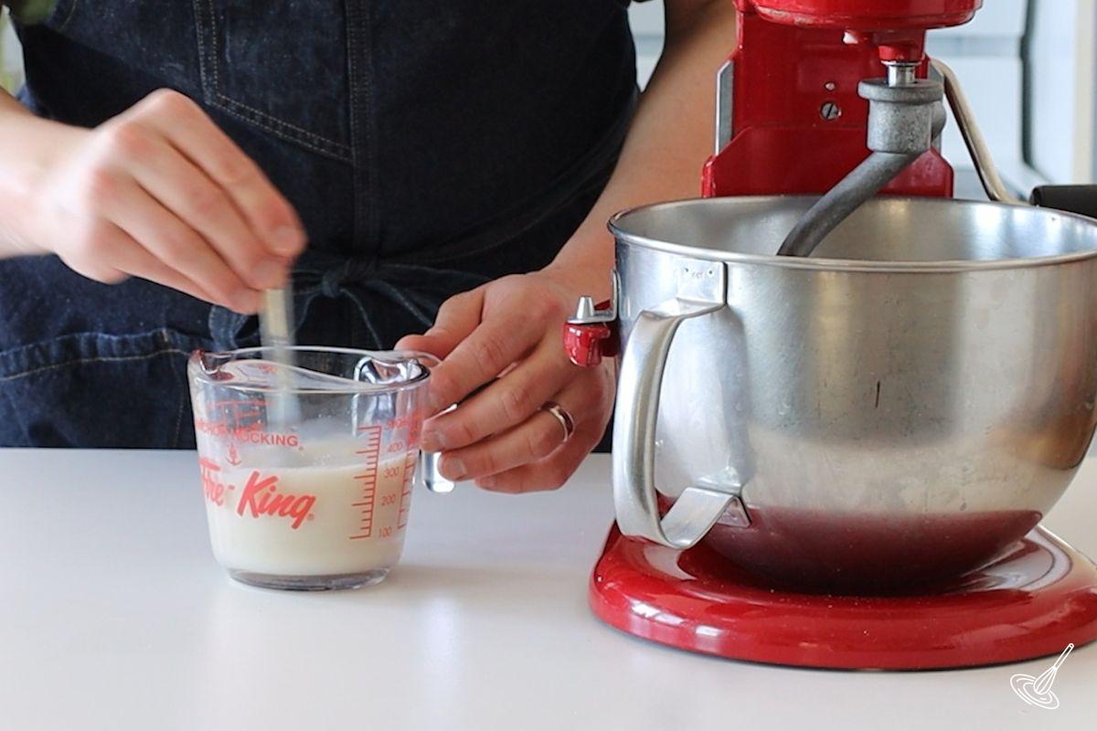 Someone stirring a yeast mixture.