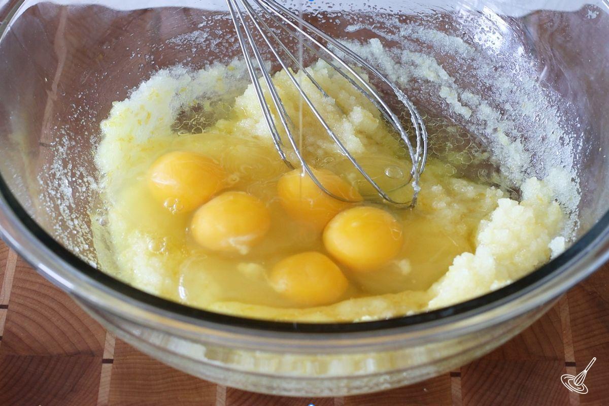 Someone whisking eggs into a sugar mixture. 