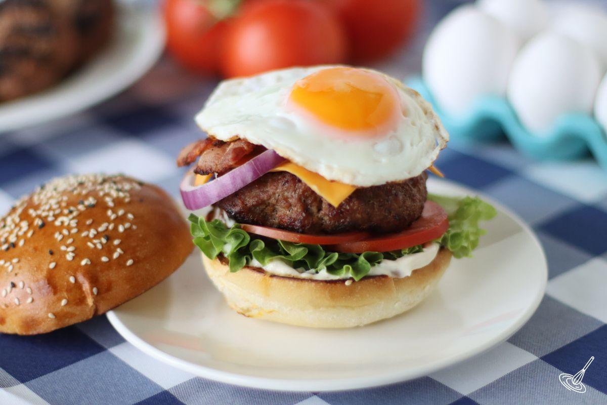 A Bacon Egg Cheese Burger on a plate.