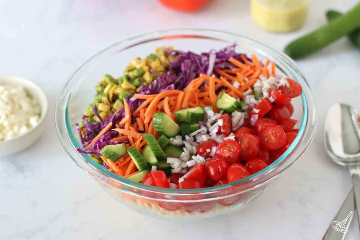 A bowl of Rainbow Pasta Salad before being mixed.