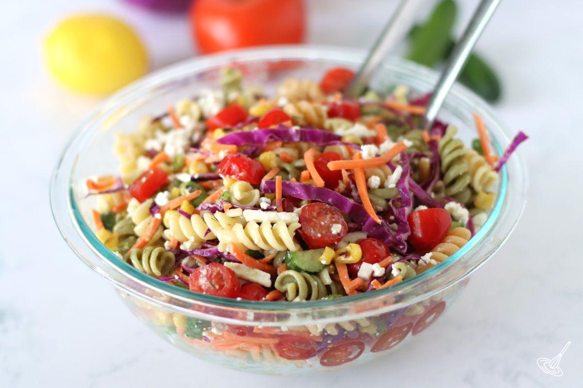 A serving bowl of mixed Rainbow Pasta Salad.
