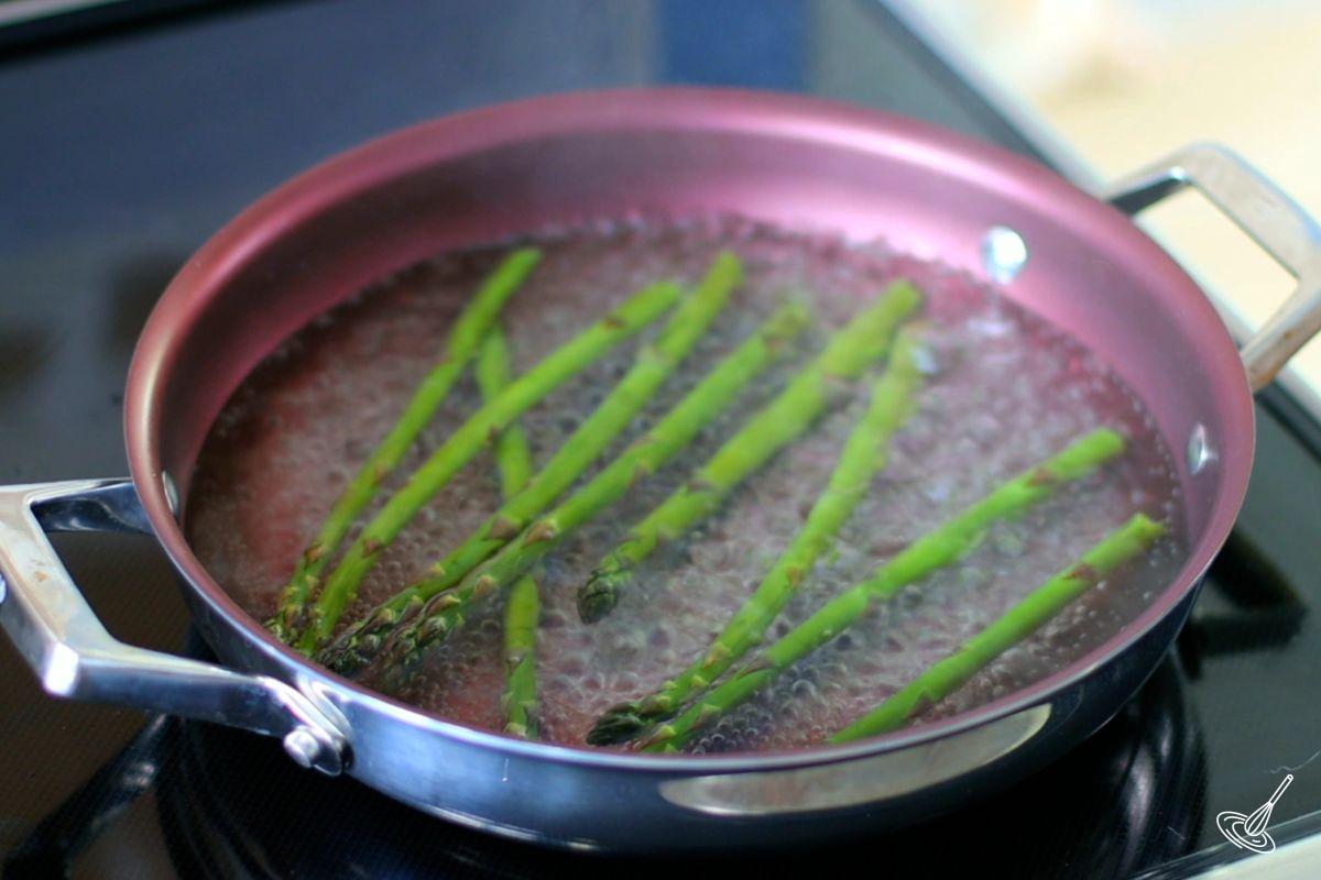 Asparagus blanching in a pan of boiling water.