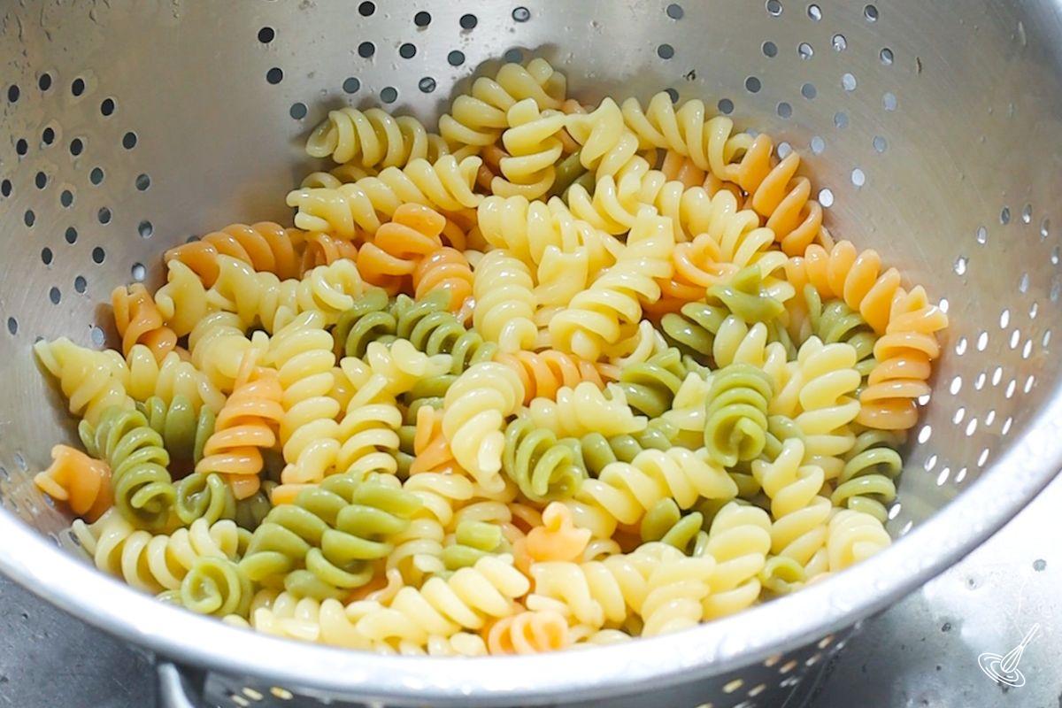 Cooked pasta in a colander. 