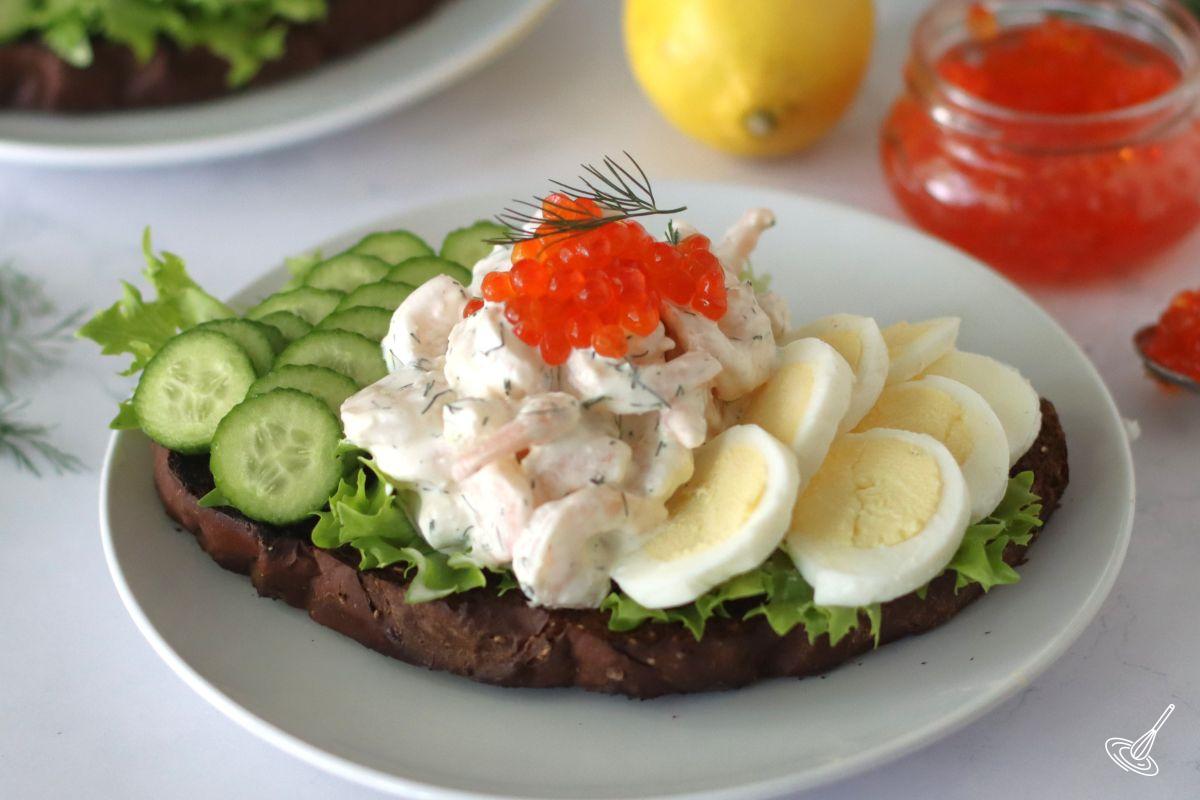 Swedish Shrimp Salad on top of a toast with lettuce, eggs, and cucumber. 