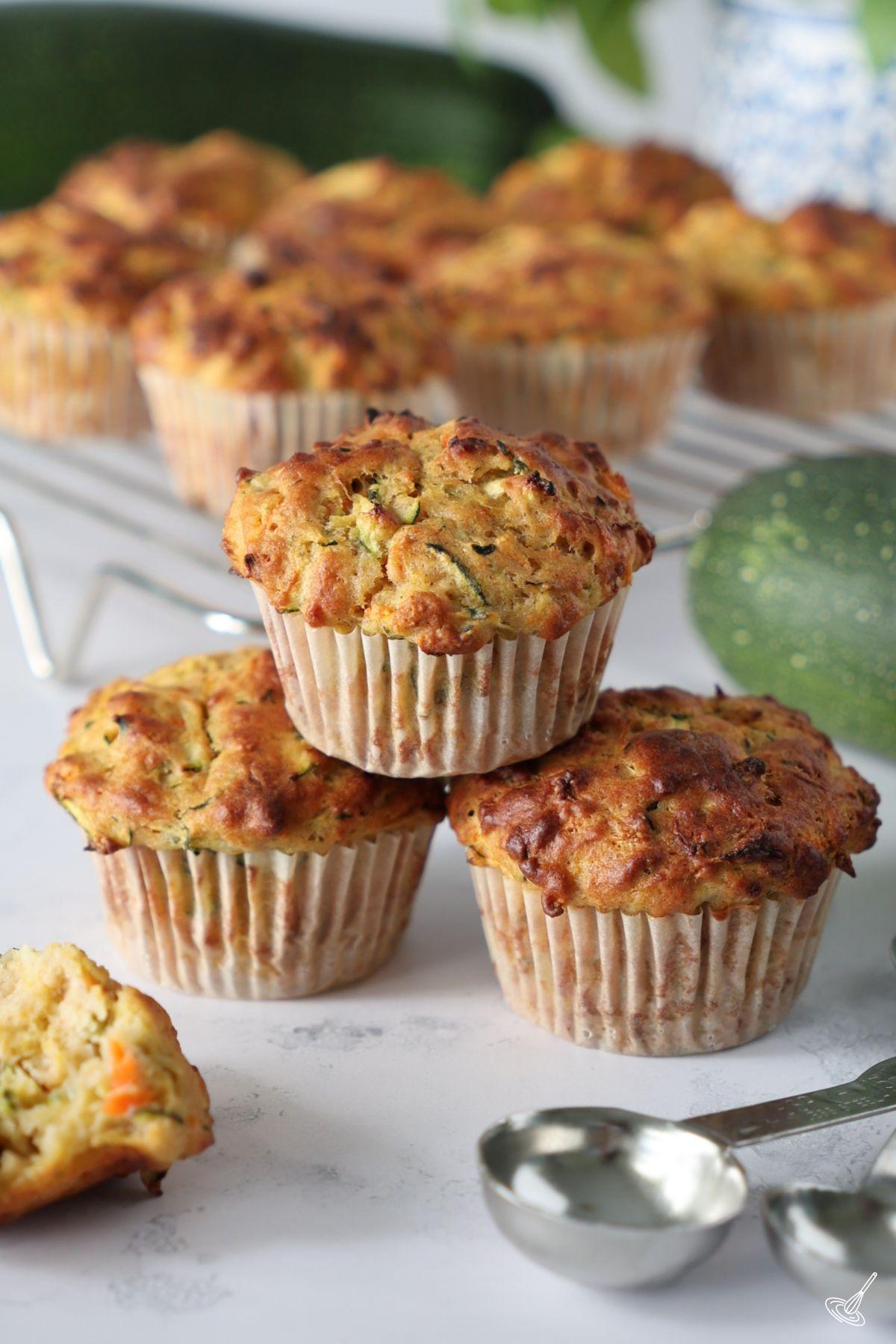 Carrot Cake Zucchini Muffins stacked on the counter.