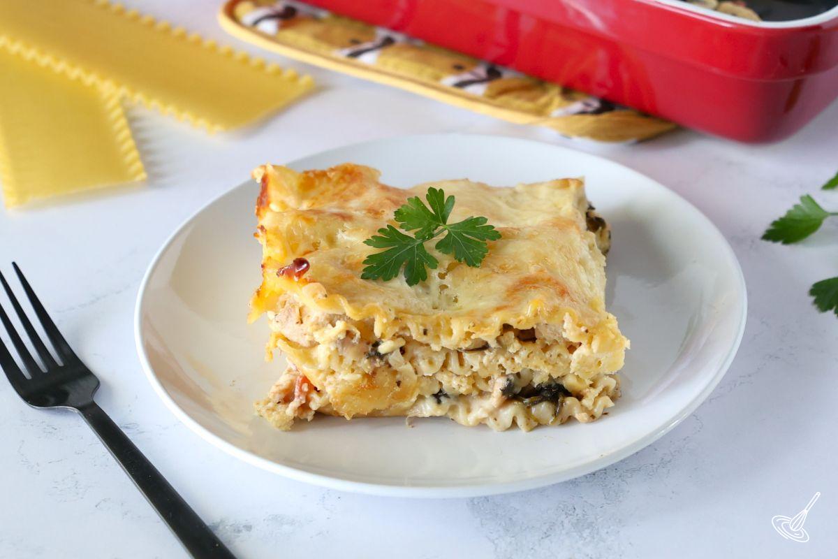 A slice of chicken spinach lasagna on a plate.