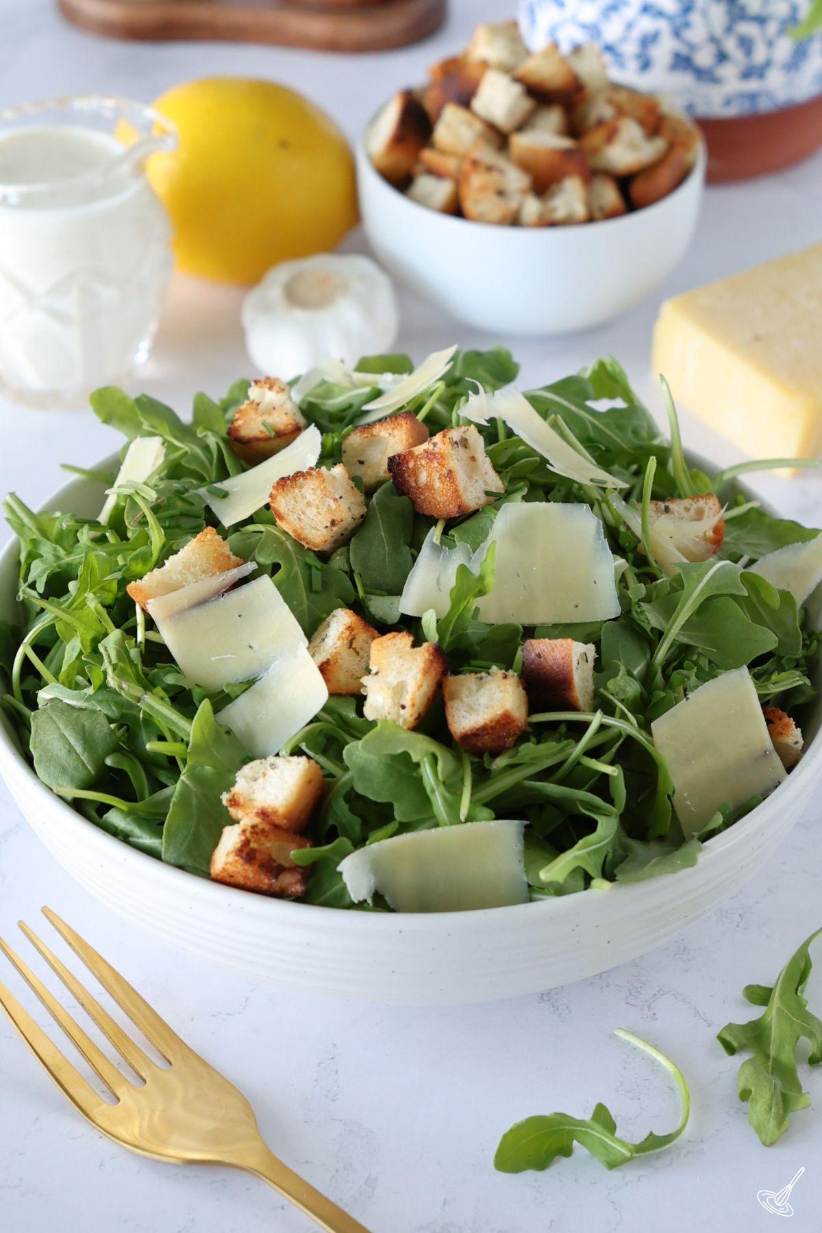 Arugula Caesar Salad in a serving bowl.