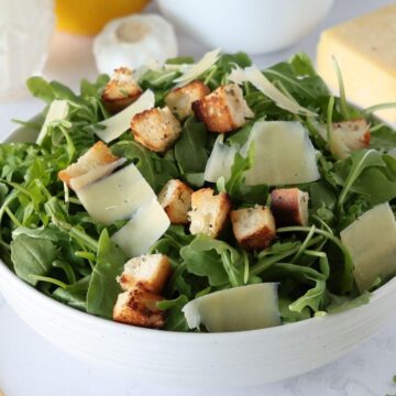 Arugula Caesar Salad in a serving bowl.
