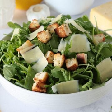 Arugula Caesar Salad in a serving bowl.