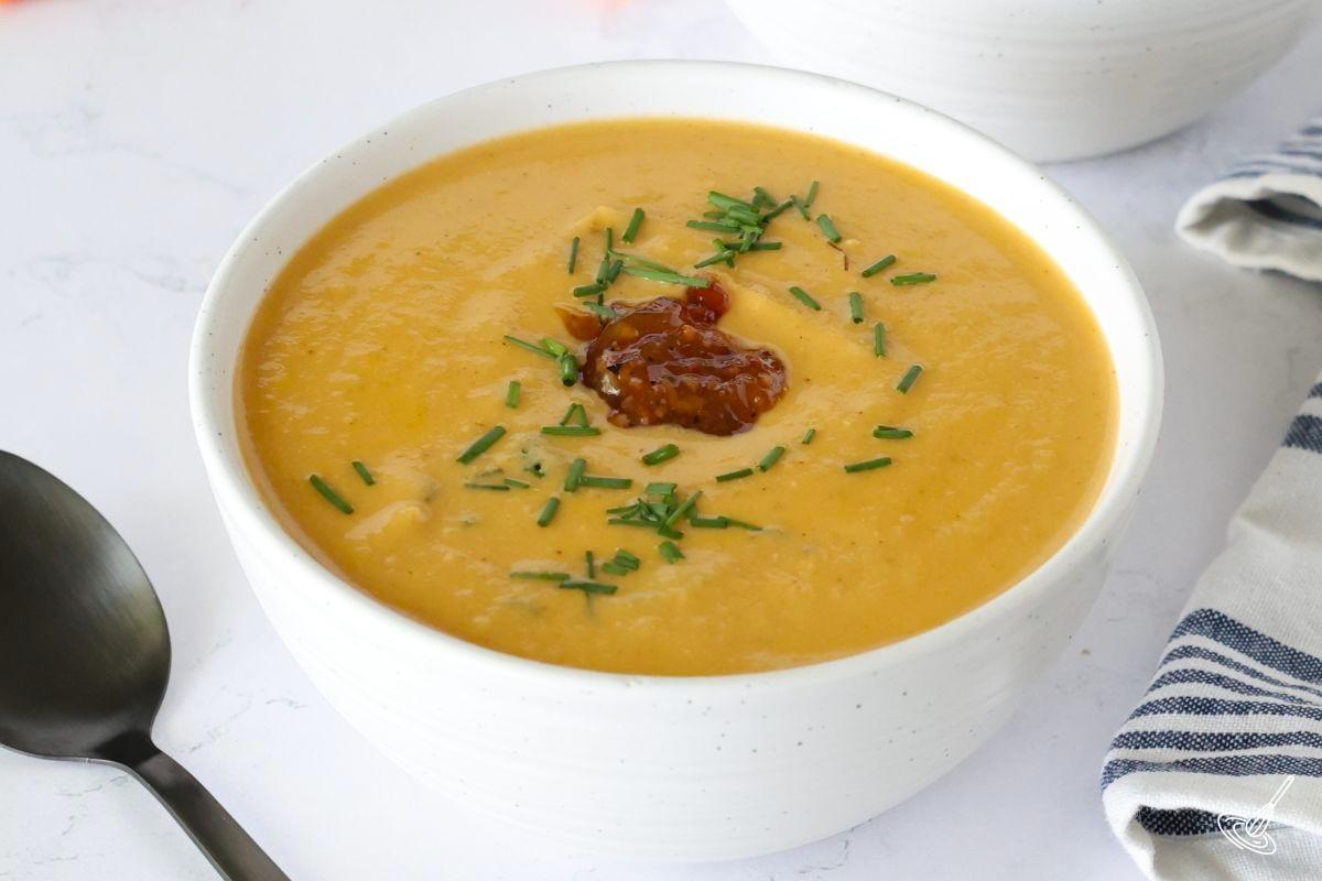 A white bowl of cauliflower bisque soup. 