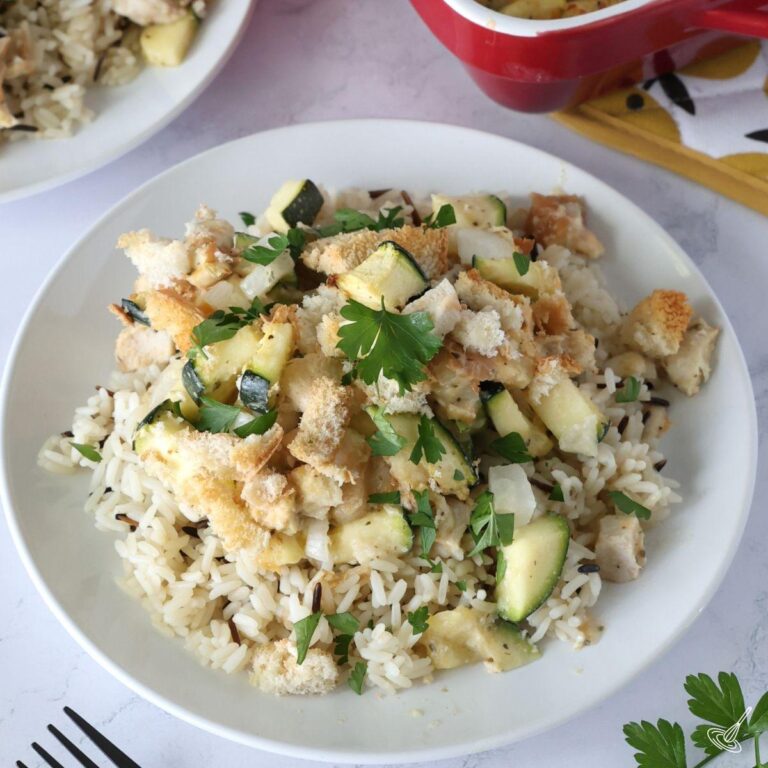 Chicken and Zucchini Bake over rice on a plate.