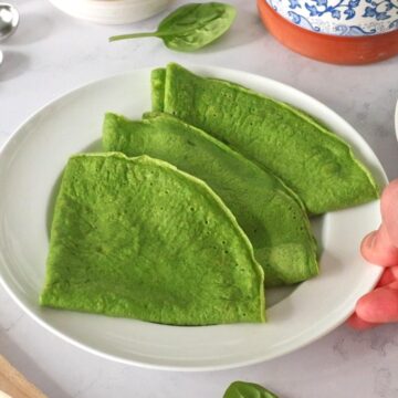 Cooked Spinach Crepes on a plate.