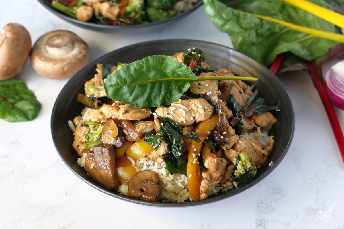 Chicken Stir Fry with Swiss Chard in a bowl over rice. 