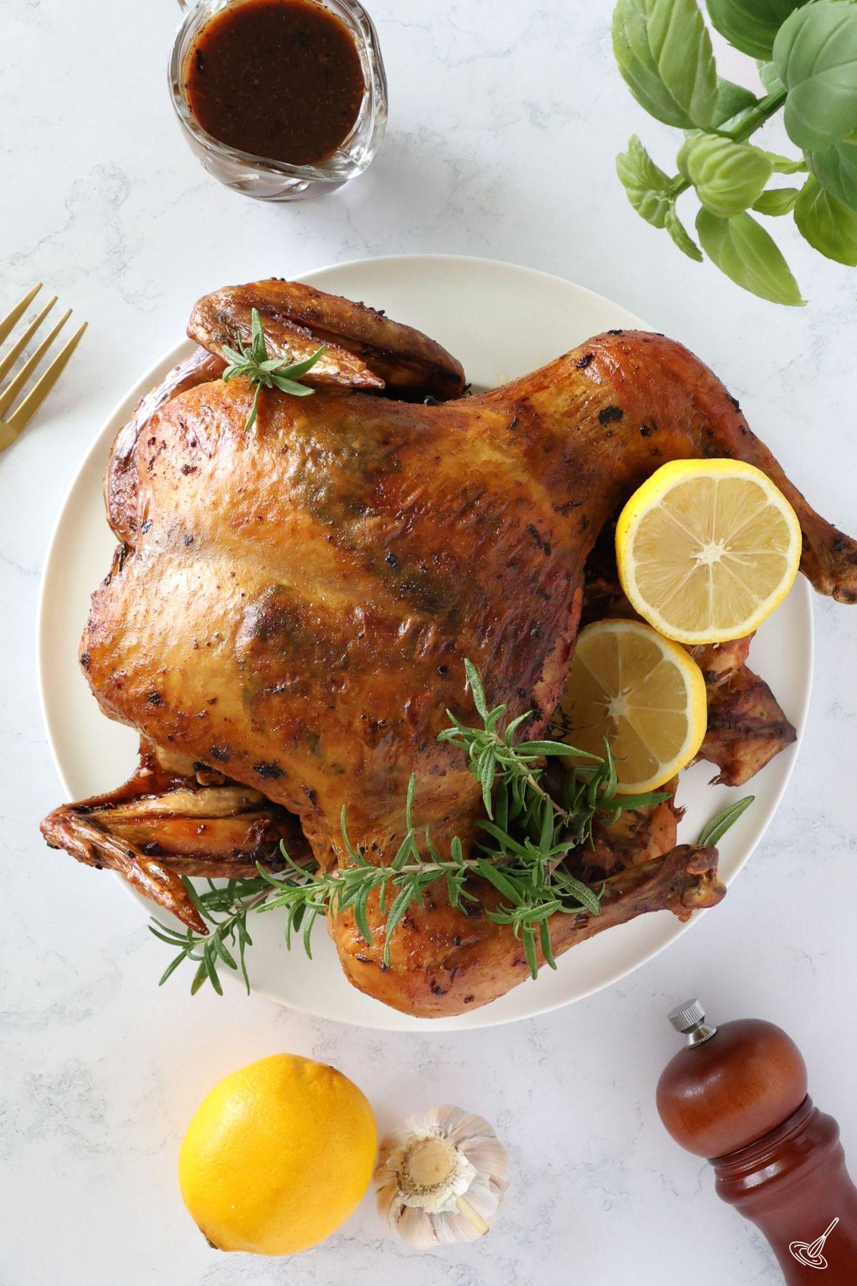 An Italian Roast Chicken on a serving plate.