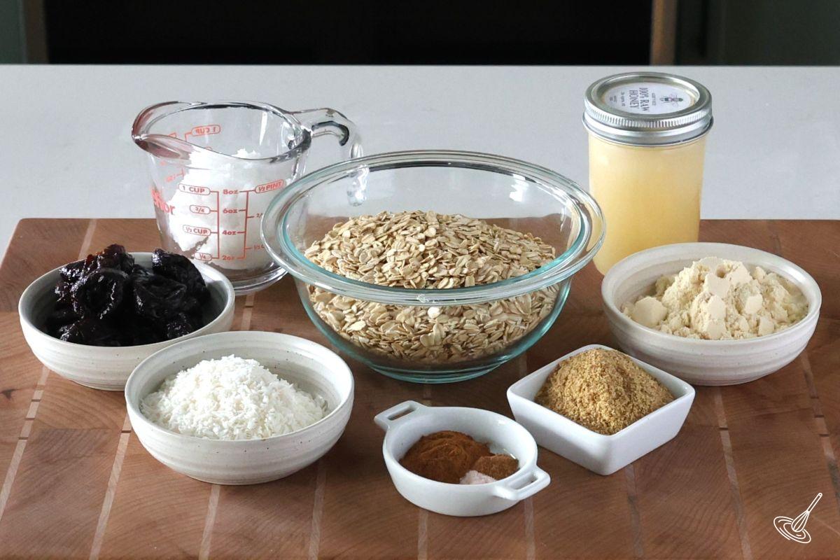 Ingredients on the counter to make nut free granola, including oats, honey, coconut, and ground flax.